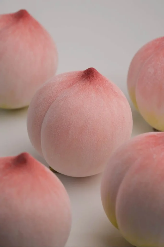 Handcrafted Jingdezhen ceramic peach with a realistic velvet matte finish
